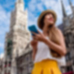 woman holding her phone in front of a church in europe, using Holafly eSIM