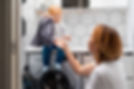 A mother and her little daughter loading laundry in the washing machine together..jpg
