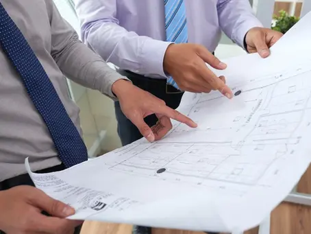 Architects discussing Residential drafting plans for a new home project