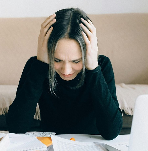 Woman with financial stress who is not using The Financial Greenhouse from Sprout to Success