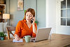 Businesswoman taking notes while talking on the phone .jpg