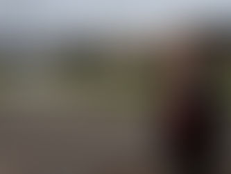 A white woman stands in front of the Treatment & Recovery Center of Douglas County.