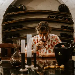 person tasting wine in cellar