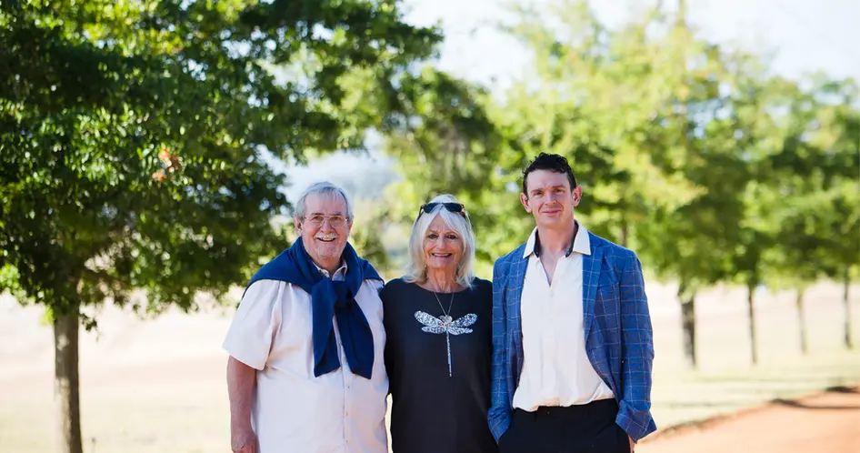 three people outdoors at vineyard