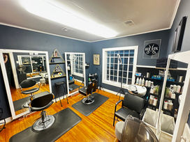 newly painted room with navy paint and hard wood floors in a historic house converted into a salon suite in rice village. The room is fully furnished and customized by the beauty professional renting there.