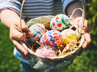 Colorful Easter eggs in basket. Kids hunt for eggs outdoors.