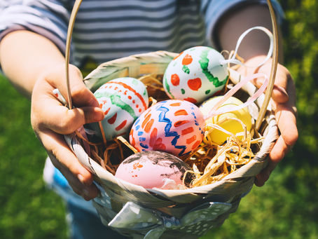 Colorful Easter eggs in basket. Kids hunt for eggs outdoors.