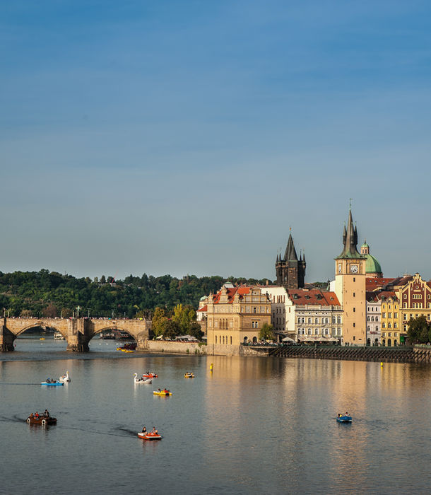 Prague Castle and Charles Bridge over Vltava River at sunset, Czech Republic cityscape, European heritage travel destination.
