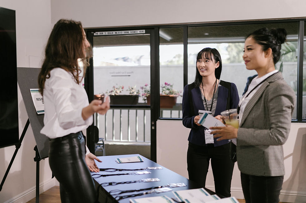 Three businesswomen talking at a conference