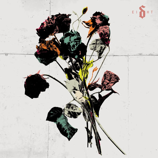 Abstract bouquet of dark multicolored flowers on a white wall, with the word EIGHT in the top right.