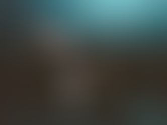 Seven people with instruments pose on a dark stage, wearing black outfits. One person sits on the floor, adding a playful mood.