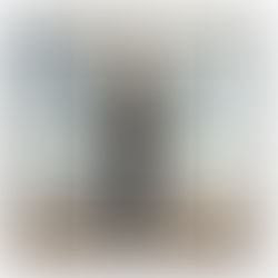 Robotic hands holding an egg with symbols in a desert. A small figure stands nearby. Text reads: Rush, Grace Under Pressure. Sky is blue with clouds.