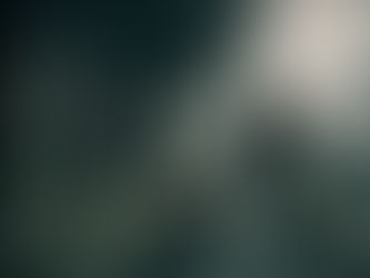 Five men pose on a sunlit walkway under a bridge. One sits cross-legged, others stand with relaxed expressions. Shadows create patterns.