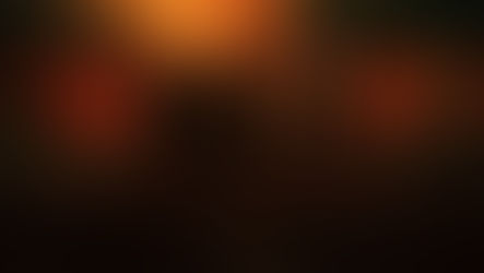 Four men stand confidently under a dramatic, fiery sky in a desolate landscape. Dark clothing and intense expressions set a moody tone.