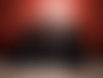 Seven people in black outfits pose confidently against a red background, exuding a bold and dynamic energy.