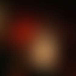 A person in a tank top with "Soul of the Seventies" stands in an empty theater with red seats and curtains, lit by warm lighting.