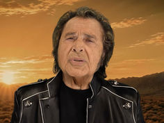 Engelbert Humperdinck on a motorcycle on a desert road at sunset, with gold text Engelbert Humperdinck and Faithfully