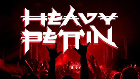 Concert crowd with hands raised in red-lit venue. Bold white text reads "Heavy Pettin" above. Excited, energetic atmosphere.