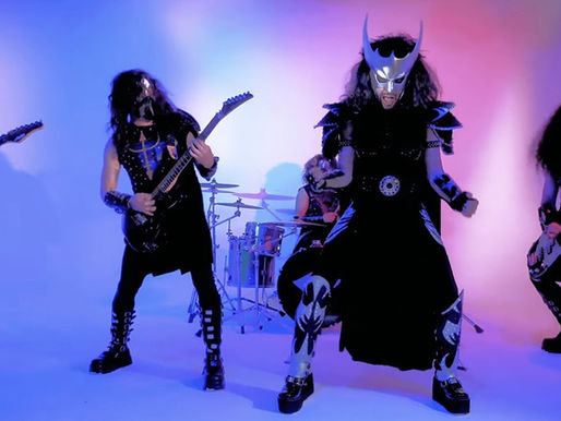 Band in metallic costumes playing instruments on stage with colorful lighting; intense and energetic mood.