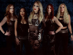 Five women in edgy black outfits with studs and fishnets pose confidently against a dark textured background, exuding a bold attitude.