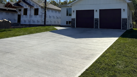 Freshly poured and finished concrete driveway by Flip Flop Construction, built to handle Northern Manitoba freeze-thaw conditions.