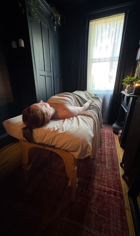 Client relaxing during a massage therapy session at Shire Wellness in Edgewater, New Jersey in a private wellness studio.