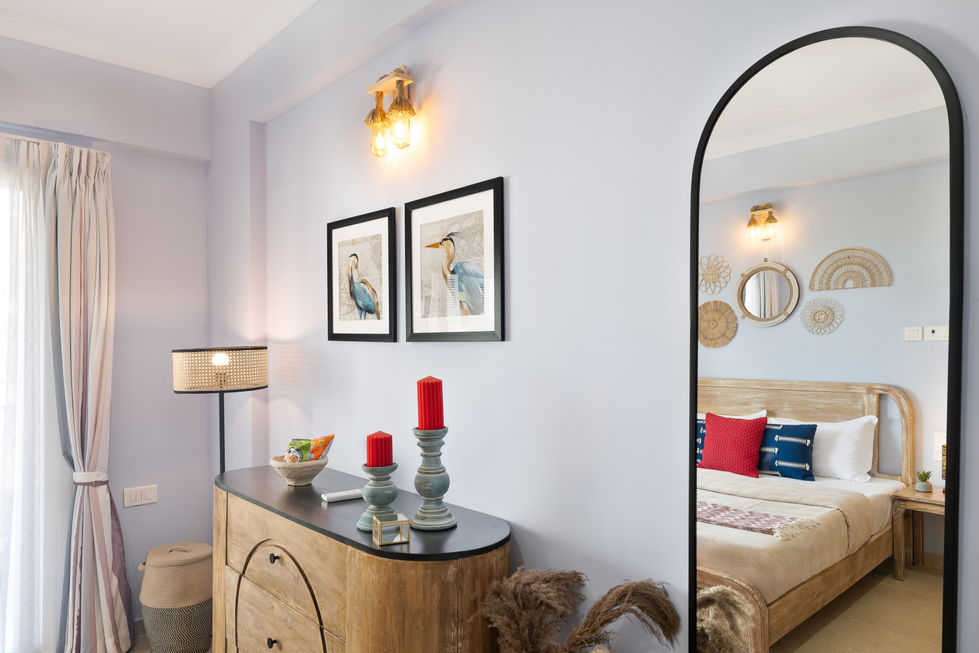 Room with wall art, candles, and a mirror.
