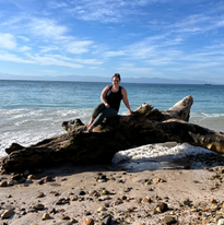 women sitting on a log