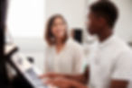 male-pupil-with-teacher-playing-piano-in