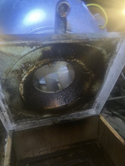 Exhaust fan inlet before cleaning with visible grease accumulation
