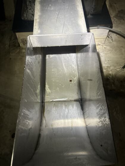 The same metal component after grease removal with original wear still visible