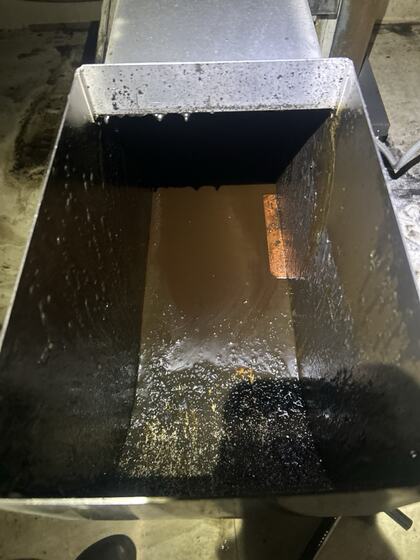 Metal exhaust component with heavy grease buildup before service