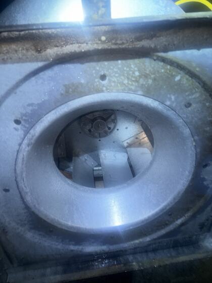 Exhaust fan inlet after cleaning showing the original metal and remaining surface marks