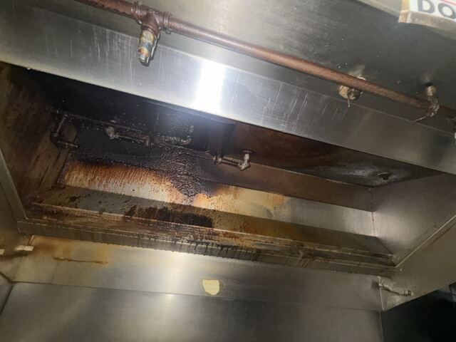 Original job photo showing grease buildup inside a kitchen exhaust hood