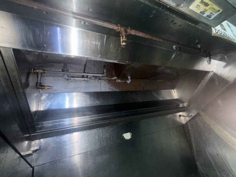 Original photo of the same hood after cleaning, with the original piping and surface wear preserved
