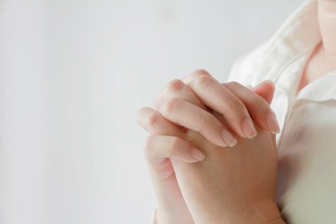 Hands folded in prayer - Image by DepositPhotos