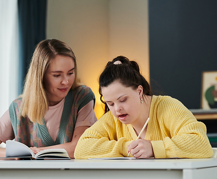 Support worker assisting young woman whilst learning 
