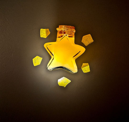 A glowing, star-shaped glass bottle filled with a golden yellow liquid, sealed with a cork. Surrounding the bottle are small, translucent yellow shards that resemble pieces of a magical or crystallized material. The bottle appears to emit a soft light, casting a gentle glow on a dark background.