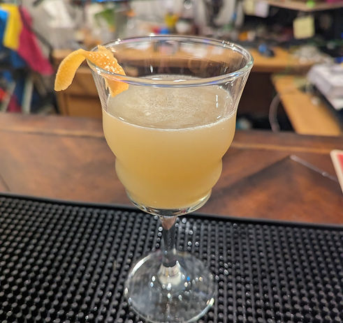 A rather yellowish looking drink despite it's name. A lil grapefruit twist hangs on for dear life (not really hanging, it's balancing ever so properly up there on that rim)