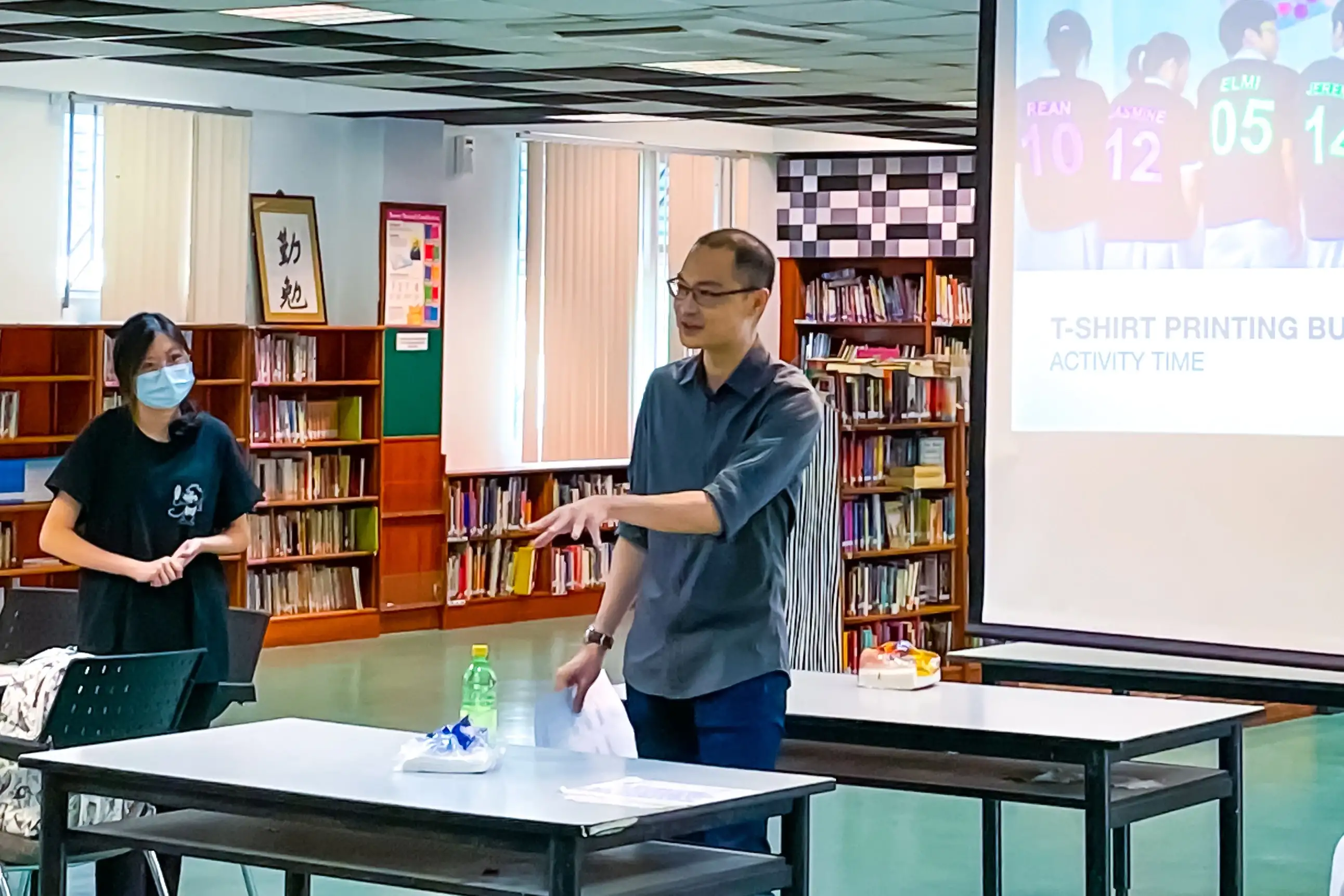 a business industry professional speaking in front of audience in a classroom full of students