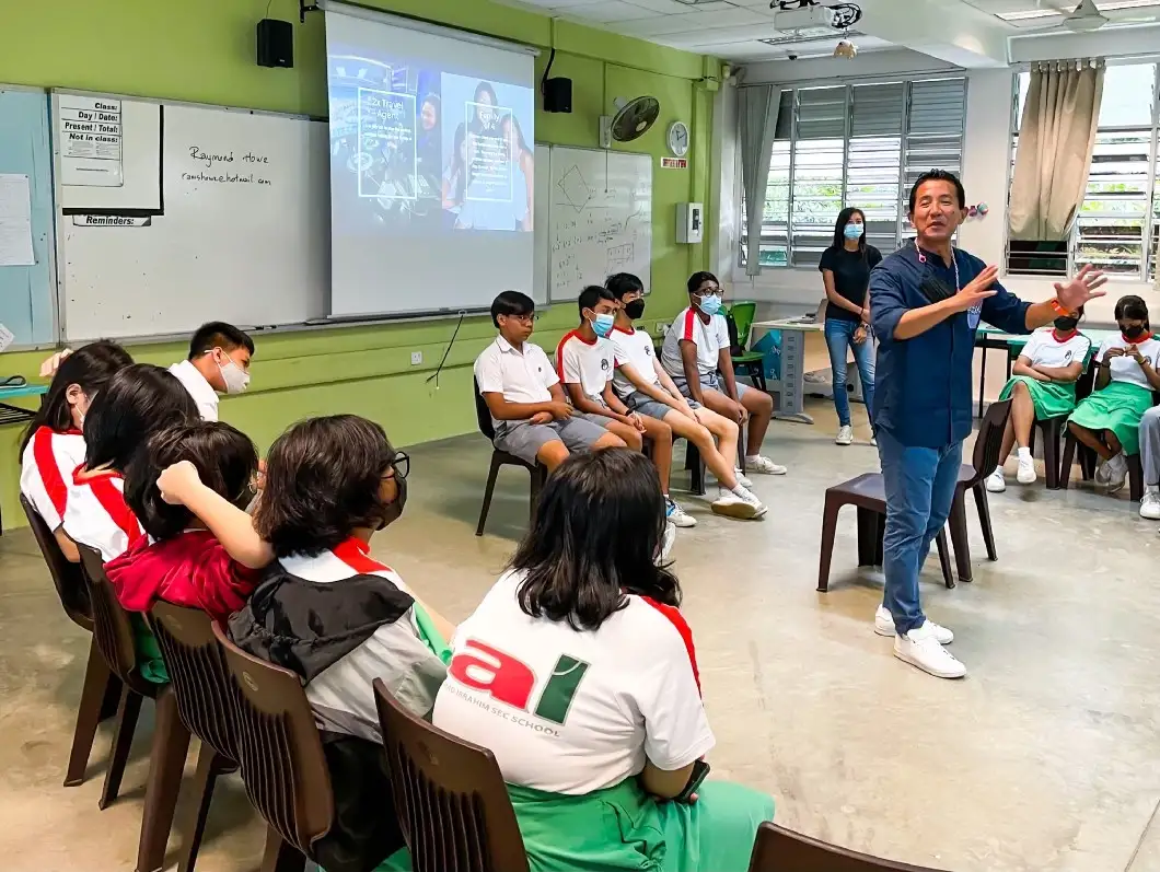 A hospitality industry professional talking to students in a classroom