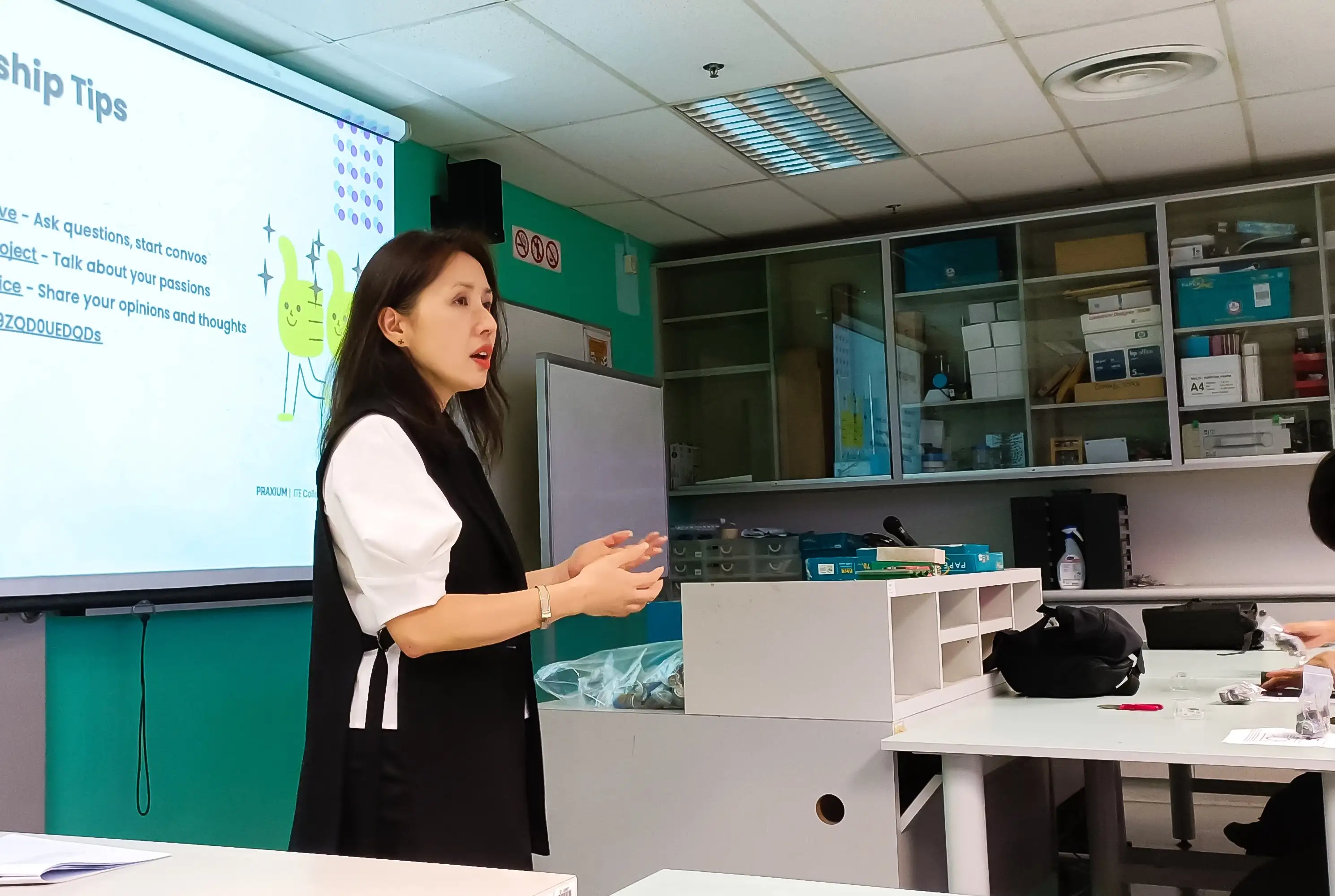 Facilitator talking in front of an audience of ITE students