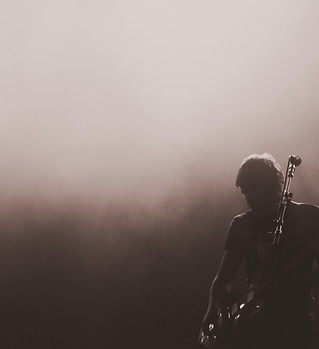 Plays guitar on stage