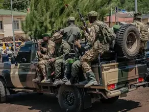 Military personnel traveling in a pickup truck in eastern DRC during ongoing conflict involving M23 rebels and the withdrawal of foreign forces from Rwanda and Uganda