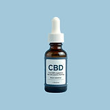 cbd bottle against a blue grey backgroun