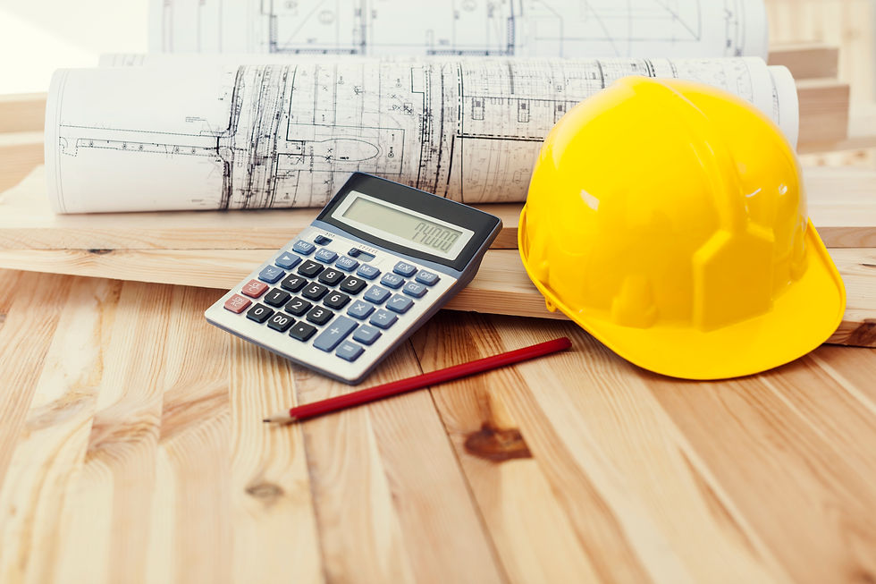 A yellow hard hat, calculator, red pencil, and rolled construction blueprints arranged on a wood surface, representing the roofing estimate and planning process.