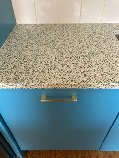 Glass worktop on blue kitchen