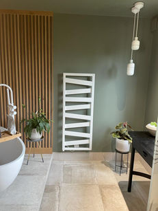 Japandi bathroom with tiled floor, panelling and raised bath