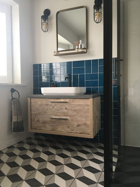 Bathroom with geometric floor and wall tiles