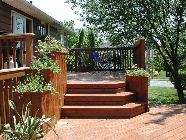 Multi-level wood deck with wide stairs and planter boxes in Arlington, Virginia
